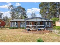 Charming single-story brick home with a cozy front porch and well-maintained landscaping at 1800 Tee Dee St, Raleigh, NC 27610