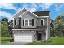 Charming two-story home with a stone-accented garage, gray siding, and black shutters surrounded by a beautiful green lawn at 200 Bruce Drive Dr, Dunn, NC 28334