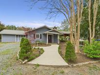 Charming single-story home featuring a landscaped front yard and inviting walkway to the front door at 2920 Ode Turner Rd, Hillsborough, NC 27278