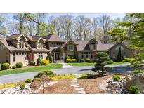 Impressive home featuring manicured landscaping, stone accents, and a welcoming entrance, all set in a mature treed lot at 301 Stone Currie Dr, Hillsborough, NC 27278