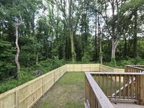 Fenced back yard with wooded view and deck, great for entertaining at 306 Cecil St, Durham, NC 27707