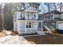 Charming two-story home with a welcoming front porch and upper level balcony at 306 Cecil St, Durham, NC 27707