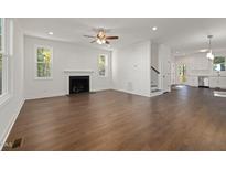 Bright living room features wood floors, fireplace, neutral walls, and plenty of natural light at 306 Cecil St, Durham, NC 27707