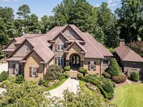 Stunning brick home with a manicured lawn and mature trees, offering timeless elegance and curb appeal at 3505 Jonaway Cir, Fuquay Varina, NC 27526