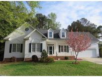 Charming white two-story home with a well-manicured lawn and flowering tree at 3537 Layton Ridge Dr, Apex, NC 27539