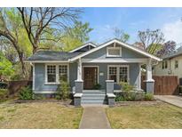 Charming blue craftsman home featuring a cozy front porch with brick accents and inviting curb appeal at 410 N Hyde Park Ave, Durham, NC 27703