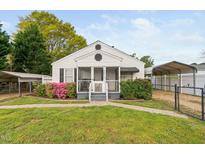Charming home featuring a cozy, screened front porch and well-maintained landscaping at 440 S Church St, Coats, NC 27521