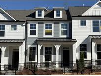 Charming two-story home with gray siding and a black iron fence at 480 Traditions Grande Blvd # 31, Wake Forest, NC 27587