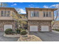 Attractive townhome with stone accents and a well-manicured lawn and a 2-car garage at 4801 Glenmist Ct # 202, Raleigh, NC 27612