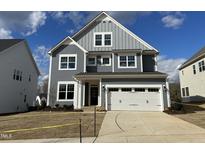 Charming two-story home features a two-car garage, and a well-manicured front yard at 5021 Aged Pine Dr # 55, Apex, NC 27523