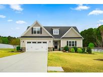 Charming single-Gathering home with a well-manicured lawn, attached two-car garage, and inviting front entrance at 81 N Lumina Ln, Clayton, NC 27527