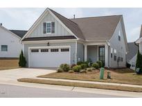 Charming home with light blue siding, an attached garage, and a well-manicured lawn at 107 Canary Ct, Raleigh, NC 27610