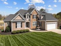 Stunning two-story home boasts beautiful stone accents, manicured lawn and mature landscaping at 107 Zaharis Cv, Raleigh, NC 27603