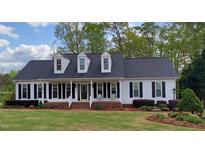 Charming single-story home with a welcoming front porch and beautiful landscaping at 117 Linwood Ln, Clayton, NC 27527