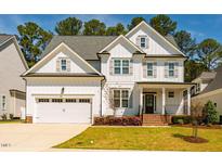Beautiful two-story home featuring a two-car garage, well-manicured lawn and landscaping at 2075 Toad Hollow Trl, Apex, NC 27502