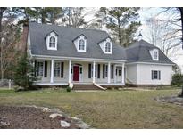 Charming home featuring a classic front porch with stately columns and a vibrant red front door at 218 Keith Hills Rd, Lillington, NC 27546