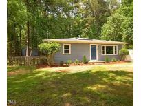 Charming single-story home featuring a well-maintained lawn and mature trees at 220 Barclay Rd, Chapel Hill, NC 27516