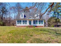 Charming two-story home with dormer windows, green shutters, and a well-maintained lawn at 30 Shannon Rd, Timberlake, NC 27583