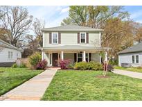 Charming two-story home with a welcoming front porch and beautifully landscaped front yard at 303 N Guthrie Ave, Durham, NC 27703