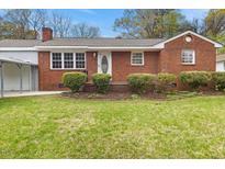 Charming brick home with a well-manicured front yard and inviting curb appeal at 324 Dare St, Burlington, NC 27217
