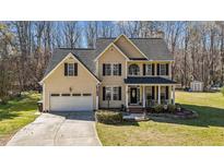 Beautiful two-story home featuring black shutters and a well-manicured front lawn at 3424 English Cir, Willow Springs, NC 27592