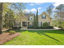 Charming home featuring a lush green lawn, manicured landscaping, and a classic architectural design at 367 Windham Way, Clayton, NC 27527