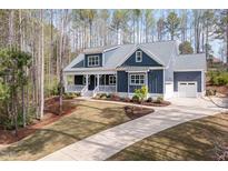 Beautiful home with a manicured lawn and a charming front porch at 370 Chapel Ridge Dr, Pittsboro, NC 27312