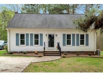 Charming single story home featuring blue shutters and landscaped front yard at 5578 Tabbs Creek Church Rd, Oxford, NC 27565