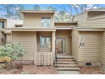 Inviting townhome front entrance featuring brick steps and a covered porch at 58 Stoneridge Rd, Durham, NC 27705