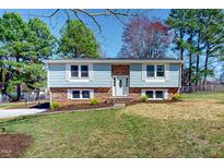 Charming two-story home with a well-manicured lawn and mature trees providing curb appeal at 72 Edgemont Ave, Roxboro, NC 27573