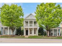 Charming two-story home with a double balcony and a well-maintained lawn and two mature trees at 7819 Acc Blvd, Raleigh, NC 27612