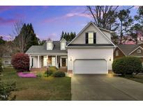Charming home featuring a manicured lawn, two car garage, and architectural roof at 801 Noconia Pl, Fuquay Varina, NC 27526