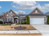 Charming exterior featuring stone accents, manicured lawn and an attached two-car garage at 103 Tanoak Ct, Durham, NC 27703
