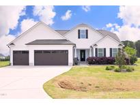 Charming two-story home with a manicured lawn, two-car garage, and inviting front porch, perfect for curb appeal at 127 Hurricane Aly, Benson, NC 27504