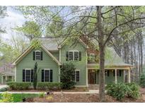 Charming two-story home boasts lush landscaping, a welcoming front porch, and a well-maintained green lawn at 160 Sweet Pine Cir, Pittsboro, NC 27312