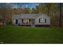 Charming single Gathering home featuring a welcoming front porch and a lush green lawn at 163 Ridge Way Ln, Clayton, NC 27520