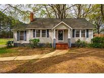 Charming single-story home featuring blue shutters, neutral siding, brick steps, and a well-maintained front yard at 2422 S Alston Ave, Durham, NC 27713