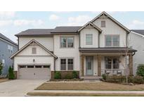 Charming two-story home with a covered front porch and an attached two-car garage at 288 Whispering Wind Dr, Chapel Hill, NC 27516