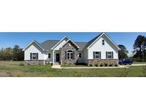 Charming new construction home featuring stone accents, a gray roof, and a well-manicured lawn at 2915 Cox Mill Rd, Sanford, NC 27332