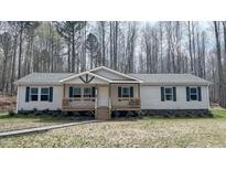 Charming single-story home with a welcoming front porch and beautiful surroundings at 3014 Split Wood Ct, Oxford, NC 27565