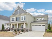 Charming two-story home with an attached garage, covered porch, and beautifully landscaped front yard at 3348 Table Mountain Pine Dr, Raleigh, NC 27616