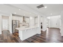 Modern kitchen with stainless steel appliances, white cabinets, and an island at 3348 Table Mountain Pine Dr, Raleigh, NC 27616