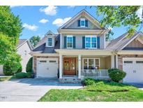 Charming two-story home with a stone and siding exterior, covered porch, and well-manicured front yard at 44 Grandwood Cir, Durham, NC 27712