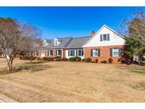 Charming one-story brick home with a manicured lawn and beautiful landscaping at 504 W Brocklyn St, Benson, NC 27504