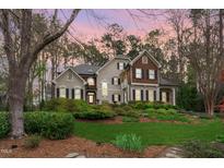 Stately two-story home featuring lush landscaping, stone accents, and a welcoming front entrance at 506 Rose Point Dr, Cary, NC 27518
