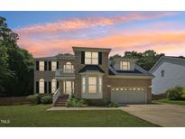 Beautiful two-story brick home with manicured lawn and attached two-car garage at 5144 Pinehall Wynd, Raleigh, NC 27604