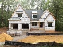 New construction features a two-car garage and landscaping ready for customization at 5205 Quail Meadows Dr, Raleigh, NC 27609