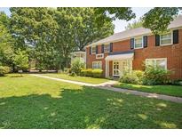 Two story red brick building with manicured lawn and mature trees at 907 St Marys St, Raleigh, NC 27605