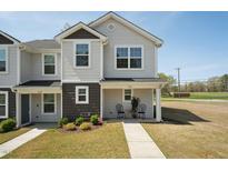Charming townhome with a welcoming front porch and well-maintained landscaping at 918 E Green St # A102, Franklinton, NC 27525