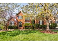 Charming brick home with a manicured lawn and mature trees in full bloom at 9320 Teton Pines Way, Raleigh, NC 27617
